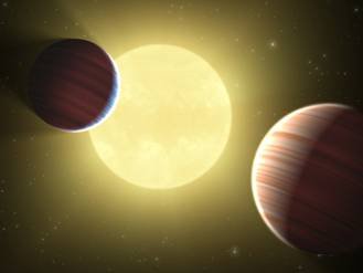 Concepto artístico de dos planetas del tamaño de Saturno dentro del sistema planetario Kepler-9.